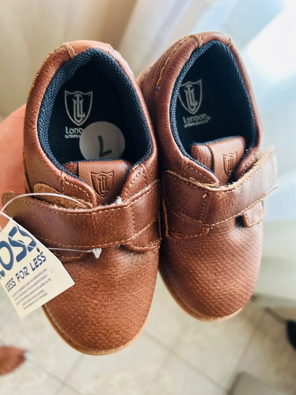 Brown London Underground boys' casual dress shoes feature a strap closure.